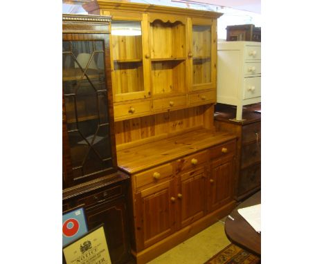 A modern pine dresser, the base with three short drawers over three cupboard drawers, the upper section with three short draw