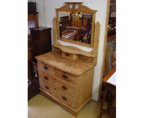 An Edwardian pine dressing table, with two short drawers over two long, the mirrored back over a shelf with small central dra