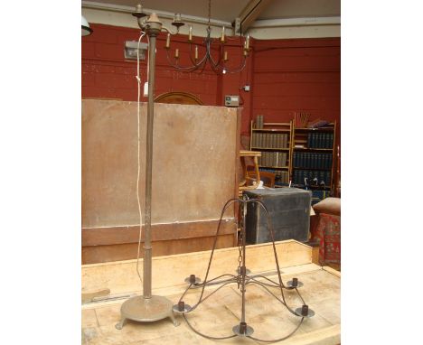 A 20th Century brass standard lamp, a/f with a wrought iron chandelier. 