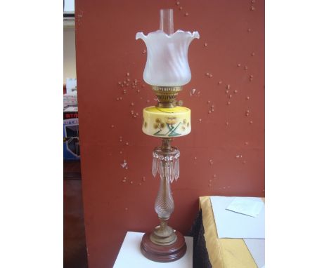 A Victorian Veritas oil lamp with frosted glass shade, clear chimney brass burner and yellow glass reservoir decorated in ena