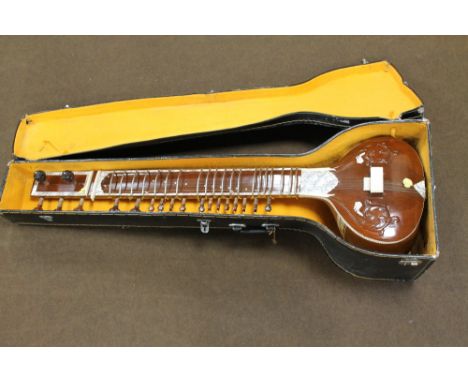 AN INDIAN SITAR, with bone and mother of pearl inlay and panels, painted detail, in a fitted case, L. 125 cm Buyers - for shi