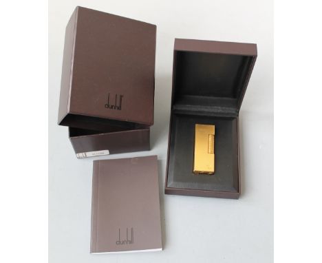 A GOLD PLATED 'DUNHILL, ROLLAGAS' CIGARETTE LIGHTER, in original box, with instruction book and slip cover Buyers - for shipp