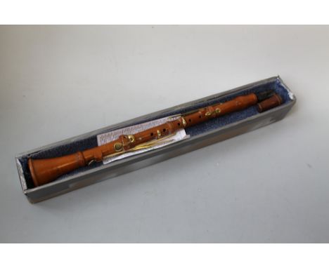 AN ANTIQUE BOXWOOD CLARINET, with brass fittings, marked 'D'Almaine & Co., Late Goulding & D'Almaine, New Bond Street, London