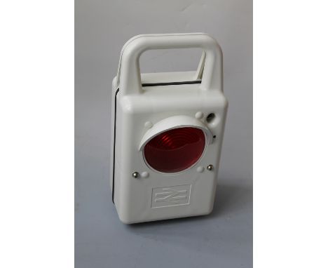 A BRITISH RAILWAYS BATTERY TAIL LAMP, in white moulded plastic, red lens, in working order Buyers - for shipping pricing on t