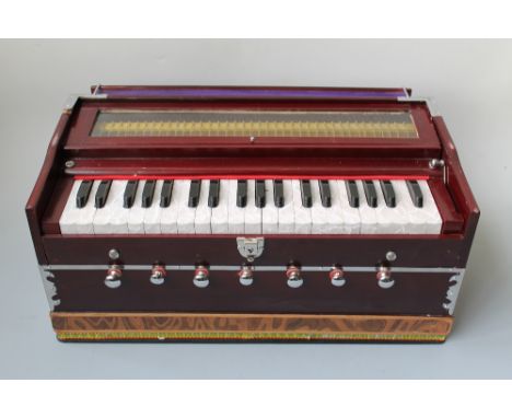 A MODERN INDIAN PUMP ORGAN, with mahogany effect case, with faux mother of pearl keys, in soft cover carry case, 54 x 27 x 25