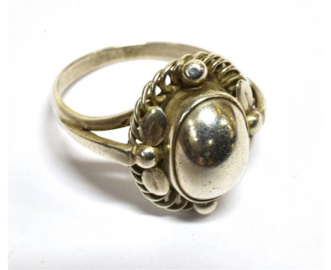 A GEORG JENSEN SILVER 'MOONLIGHT BLOSSOM' RING model 1, the head in the form of a central oval dome within a bead, twin-leaf 