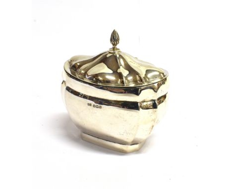 A SILVER SHAPED OVAL TEA CADDY  with a hinged and domed cover with a writhen finial, mark of Walker &amp; Hall, Sheffield 192