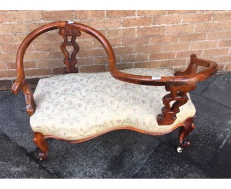 A VICTORIAN FRUITWOOD FRAMED CONVERSATION SOFA  the S shaped top rail on opposing pair of carved and pierced splats, the shap