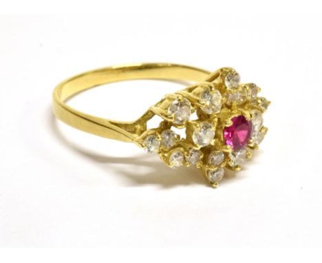 A SYNTHETIC RUBY AND CUBIC ZIRCONIA ABSTRACT CLUSTER DRESS RING centred with a round mixed-cut synthetic ruby within a near-c