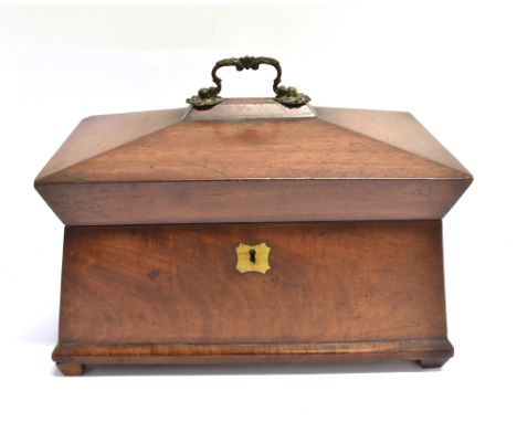 A VICTORIAN MAHOGANY TEA CADDY OF SARCOPHAGUS FORM  the interior with two compartments flanking space for mixing bowl, 31cm w