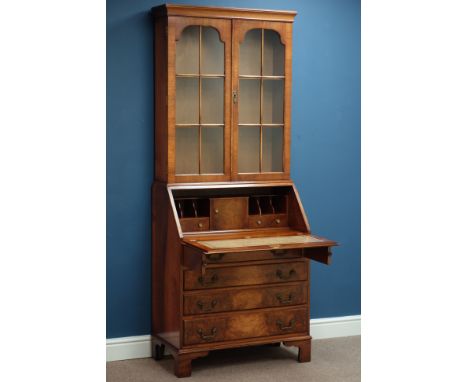 Mid 20th century walnut and figured walnut bureau bookcase, fall front and four drawers, raised astragal glazed bookcase, bra