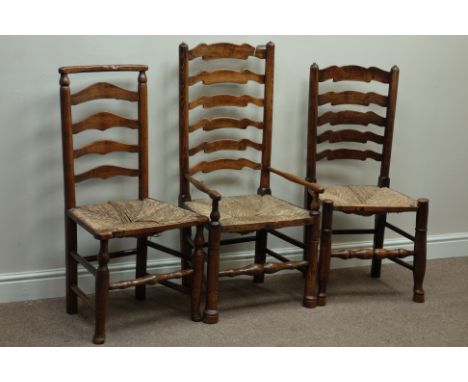 Three early 19th century country elm and oak ladder back chairs with rush seats   Condition Report   Click here for further i