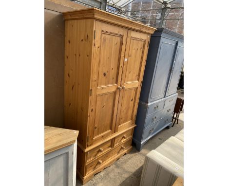 A PINE TWO DOOR WARDROBE WITH TWO SHORT AND ONE LONG DRAWER TO BASE, 40.5" WIDE