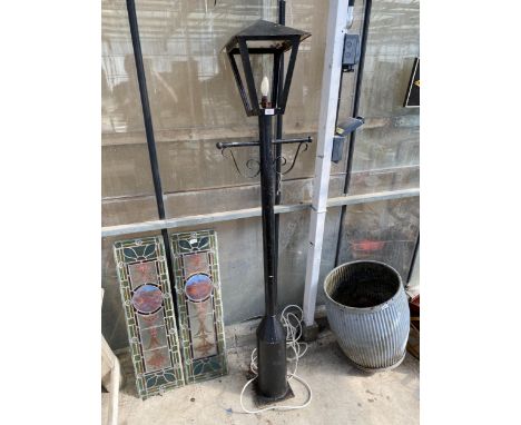 A DECORATIVE METAL GARDEN LAMP POST BELIEVED IN WORKING ORDER BUT NO WARRANTY