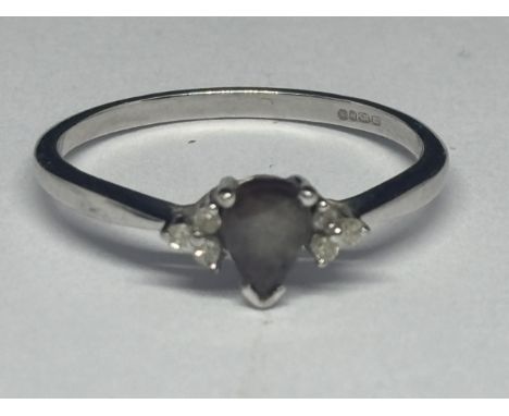 A MARKED 9 CARAT WHITE GOLD RING WITH TEARDROP AMETHYST AND SIX DIAMONDS THREE TO EACH SHOULDER SIZE N/O