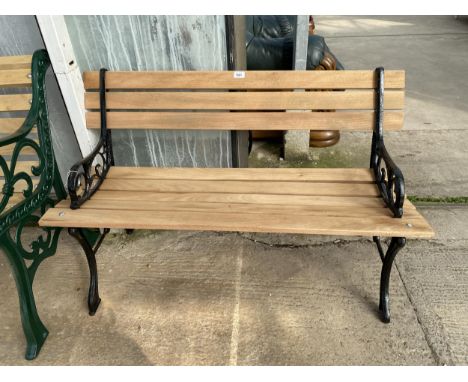 A WOODEN SLATTED GARDEN BENCH WITH CAST ENDS