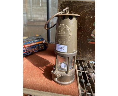 A VINTAGE BRASS PROTECTOR LAMP AND LIGHTING SAFETY LAMP