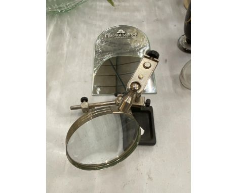 A MAURICE LACROIX OF SWITZERLAND SMALL MIRROR TOGETHER WITH A MAGNIFYING WATCHMAKERS LENS REPAIR SET