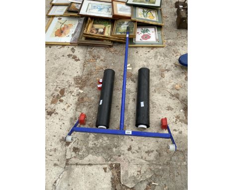 A PLASTIC ROLLING TOOL AND TWO ROLLS OF CARPET PROTECTOR