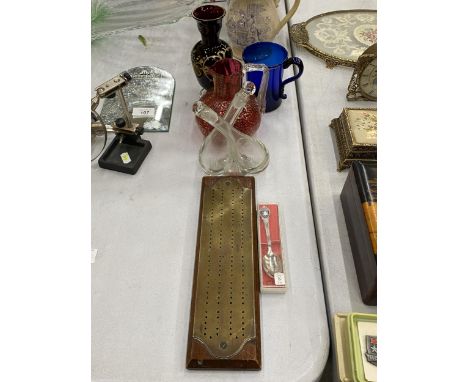 A BRASS AND WOOD CRIBBAGE BOARD, A MID CENTURY JOINED GLASS OIL AND VINEGAR CRUET BOTTLE, A RED CRACKLE GLASS JUG ETC.