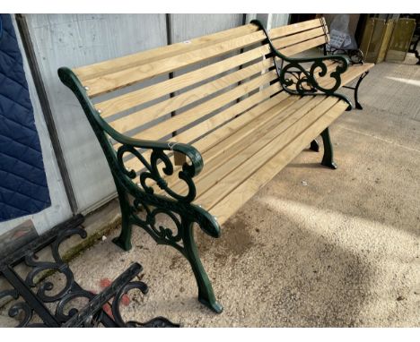 A WOODEN SLATTED GARDEN BENCH WITH CAST ENDS