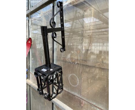A DECORATIVE METAL WALL HANGING LIGHT FITTING