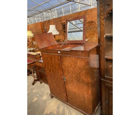A MID 20TH CENTURY MAHOGANY VANITY WARDROBE WITH LIFT UP TOP REVEALING MIRROR AND FIVE INTERNAL SLIDES ON CABRIOLE LEGS, 41" 