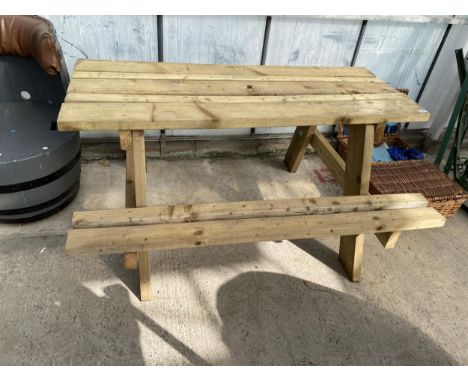 A WOODEN SLATTED GARDEN PICNIC BENCH