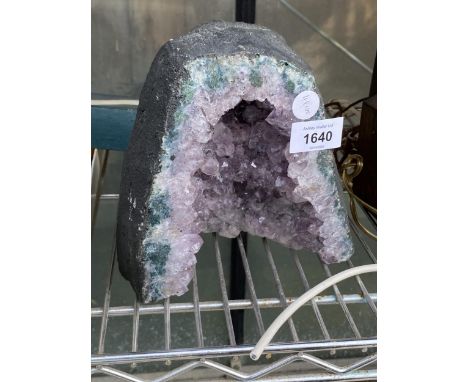 A DECORATIVE BELIEVED AMETHYST GEODE