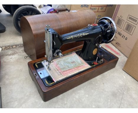 A VINTAGE SINGER SEWING MACHINE WITH WOODEN CARRY CASE