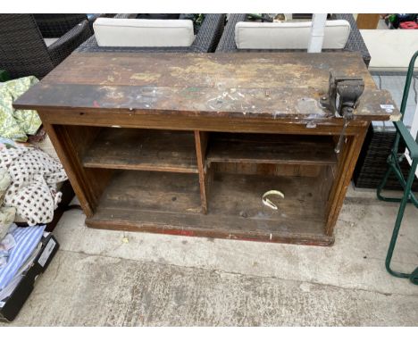 A WOODEN WORK UNIT BENCH AND A SMALL BENCH VICE