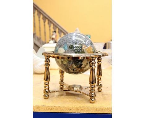 A GEMSTONE GLOBE ON A METAL STAND