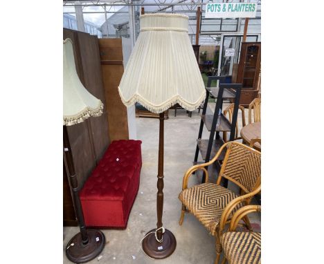 A STANDARD LAMP ON TURNED COLUMN WITH SHADE