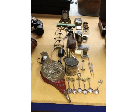 A MIXED LOT TO INCLUDE A WOODEN AND BRASS BELLOW, NAPKIN RINGS, SOUVENIR SPOONS, STIRRUPS, ETC.,
