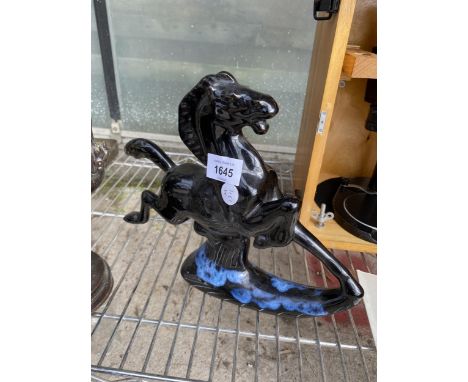 A VINTAGE BLUE AND BLACK CERAMIC GALLOPING CERAMIC STATUE WITH MARKS TO BASE