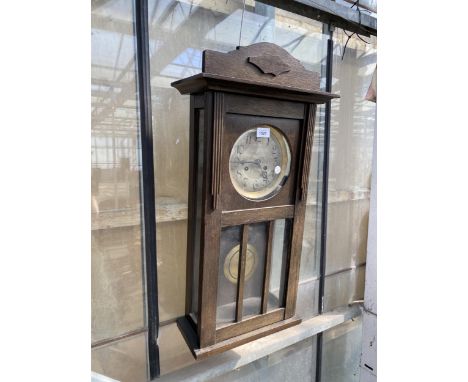 A VINTAGE OAK CASED CHIMING WALL CLOCK
