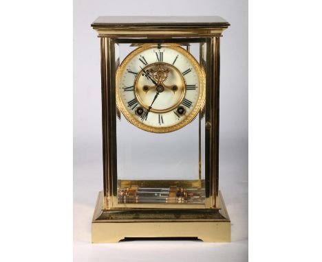 French brass four glass mantel clock circa early 20th century with twin train movement striking on a gong with mercury driven