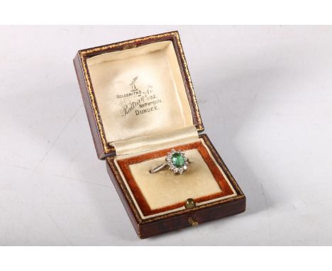 18ct white gold cluster ring with oval cut green stone encircled by diamonds, size K/L, 3.8g.&nbsp; 