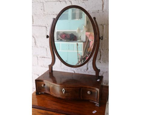 19th century mahogany toilet mirror having oval plate glass raised on a serpentine fronted plateau base having three drawers,
