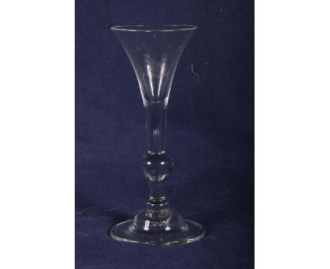 18th Century light baluster wine glass with single knop. folded foot chipped, 18cm.Interior air bubbles in places, Underside 