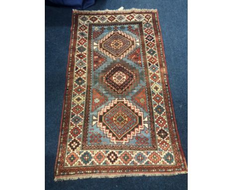 Caucasian rug with three medallions on light blue field within multiple borders, 202 x 117cm. 