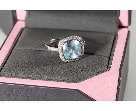 18ct white gold cocktail ring with square cut light blue stone encircled by diamond chips and also partially down shank, hall