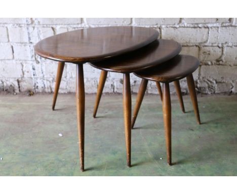Ercol nest of three pebble shaped tables, model number 354, dark tone, the largest 65cm wide. 