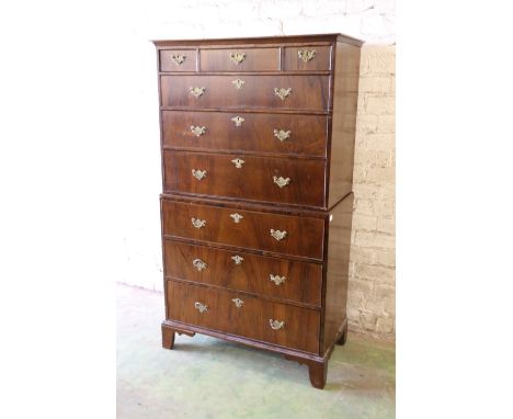 Antique style walnut veneered chest on chest, the moulded cornice above three short frieze drawers over six long drawers, rai