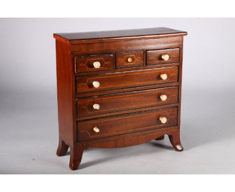 19th Century mahogany apprentice chest of three short over three long drawers on boxwood bracket feet, 22cm tall . 