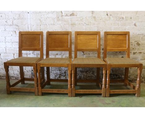 Set of four carved oak panel back dining chairs in the manner of Robert Mouseman Thompson of Kilburn, possibly apprentice pie