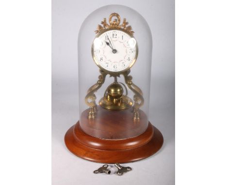 Gustav Becker brass torsion clock the enamel dial with arabic numerals on a brass skeleton frame with disc and spherical pend