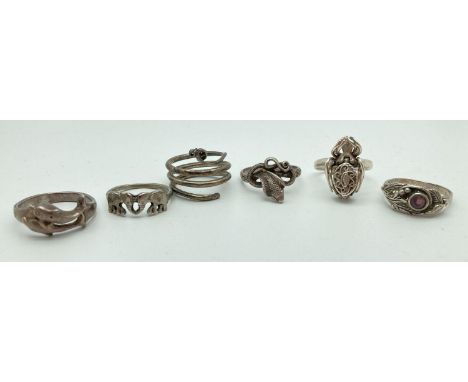 6 silver and white metal dress rings in varying styles, conditions and sizes to include animal designs. Examples include spid