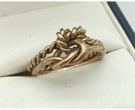 A 9ct gold double band and knot ring. One band in rope design the other plain. Full hallmarks to the plain band of ring. Tota