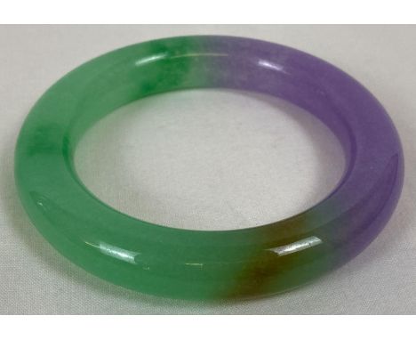 A chunky lavender jade bangle of green and lilac tones. Approx. 8.5cm diameter, 6cm inner diameter.  